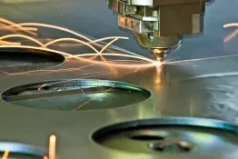 Laser cutting head cutting holes in steel plate